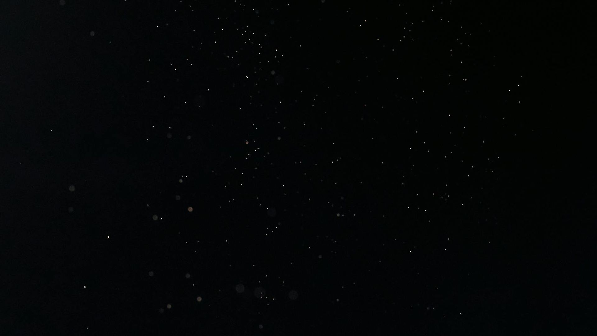 A serene, dark background with subtle light patterns suggesting movement and calm.